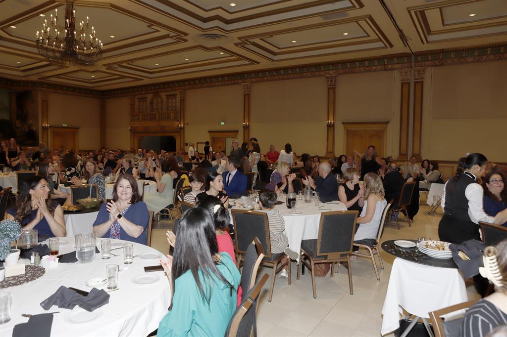 Employees around tables at the recognition event